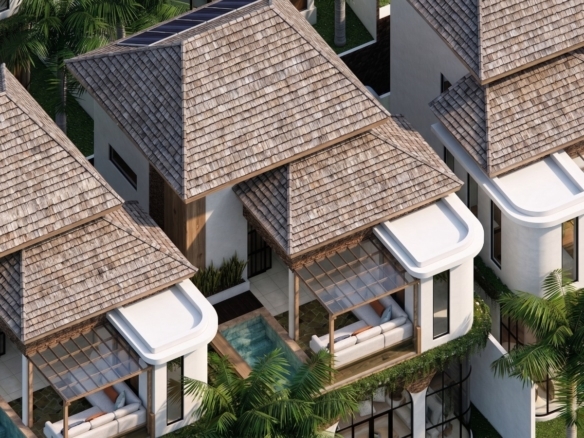 Aerial view of tropical villas with layered thatched roofs, glass sunrooms, and private seating terraces among palm trees.