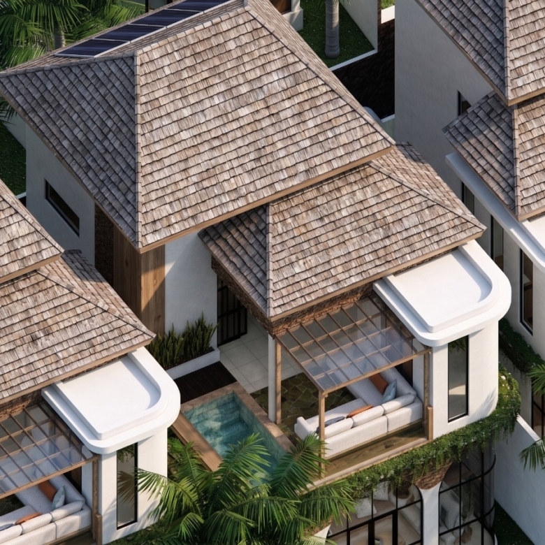 Aerial view of tropical villas with layered thatched roofs, glass sunrooms, and private seating terraces among palm trees.