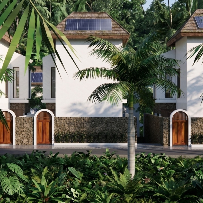 Tropical villa entrance with white walls, stone fence, wooden arched doors, and lush palm trees.