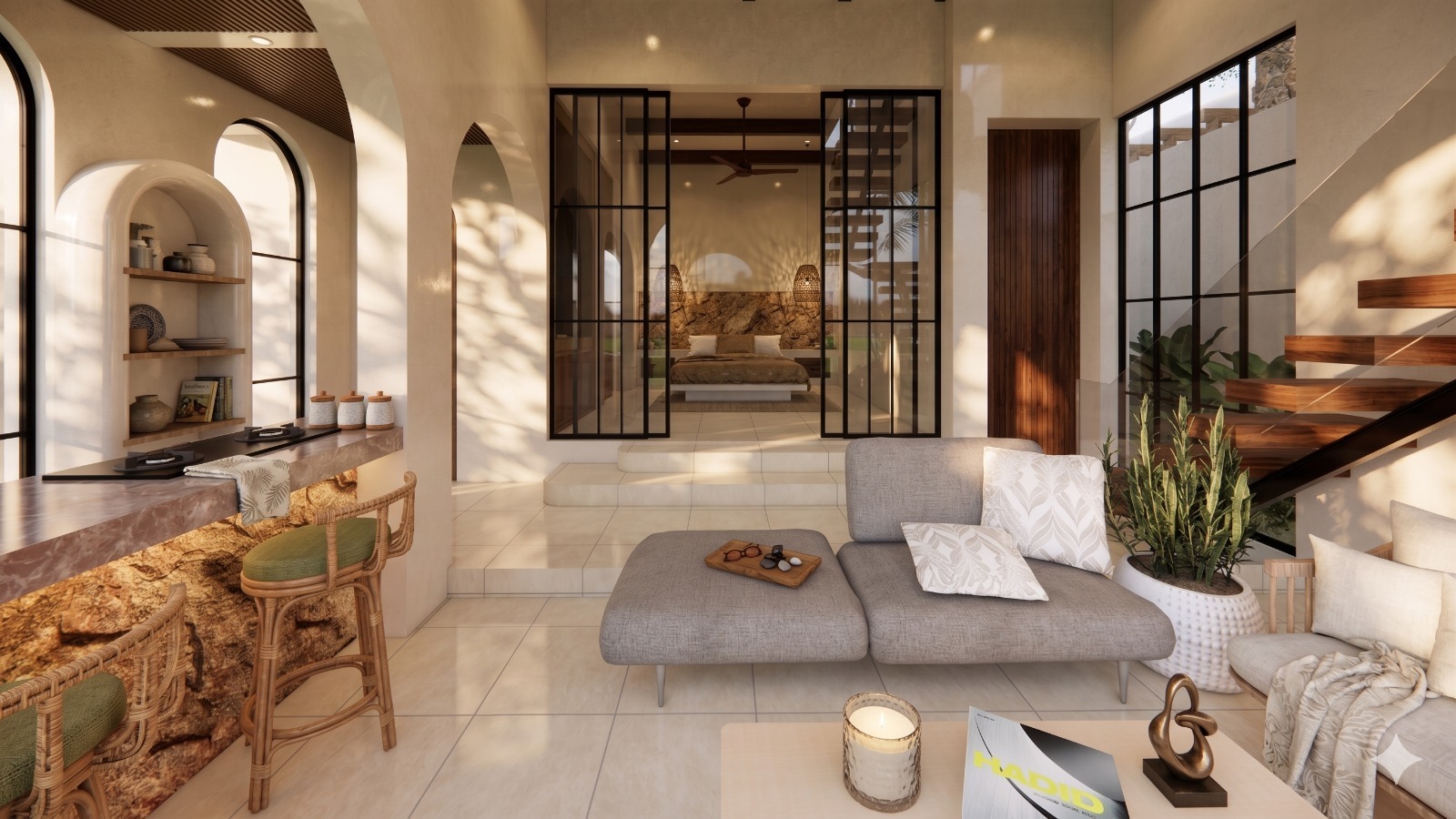 Open-plan living room with a gray sectional, neutral decor, and a glass-walled bedroom suite in the background, bathed in warm natural light.