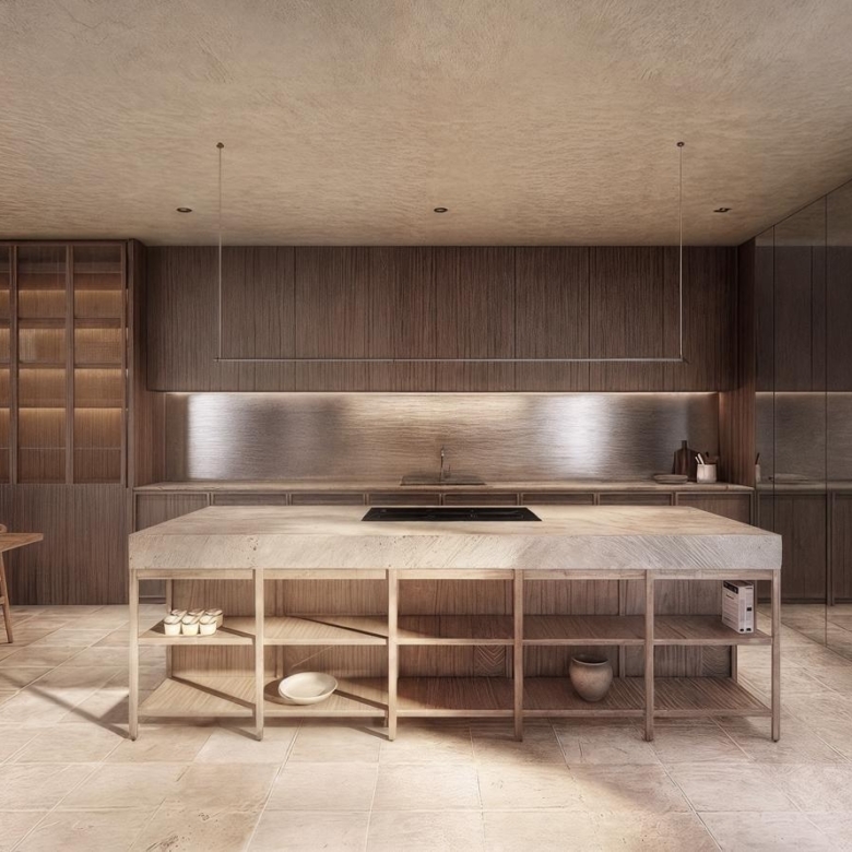 Open-concept kitchen with a large island, wooden cabinetry, and stone wall on the right.
