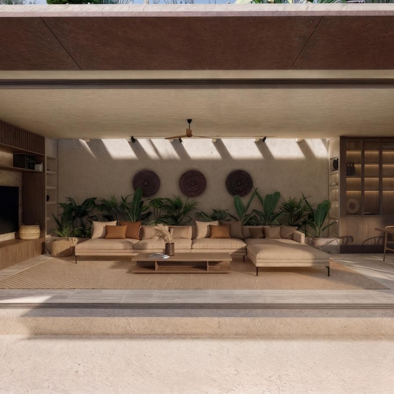 Open, sunlit indoor-outdoor living area with beige sectional sofa, wooden coffee table, and lush plants, under a covered ceiling.