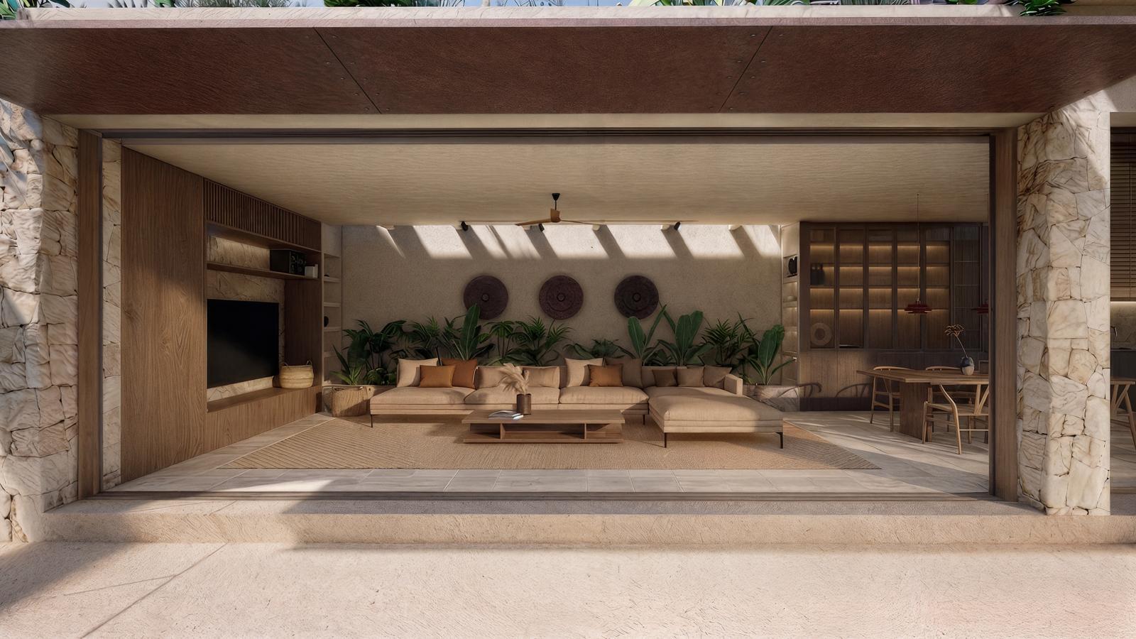 Open, sunlit indoor-outdoor living area with beige sectional sofa, wooden coffee table, and lush plants, under a covered ceiling.