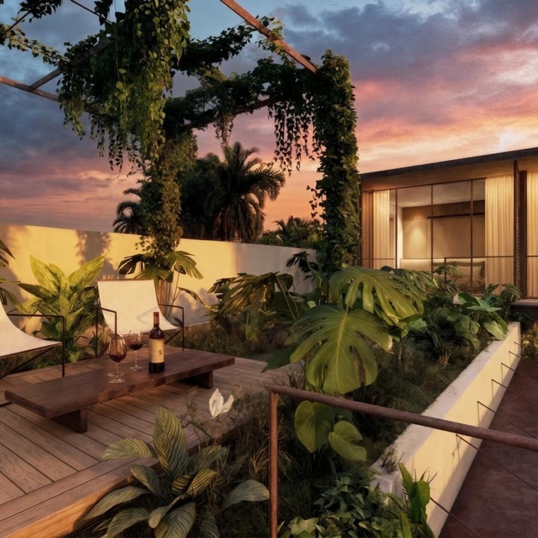 Sunset terrace with two white chairs, a wooden coffee table, wine bottle and glasses, surrounded by tropical plants.